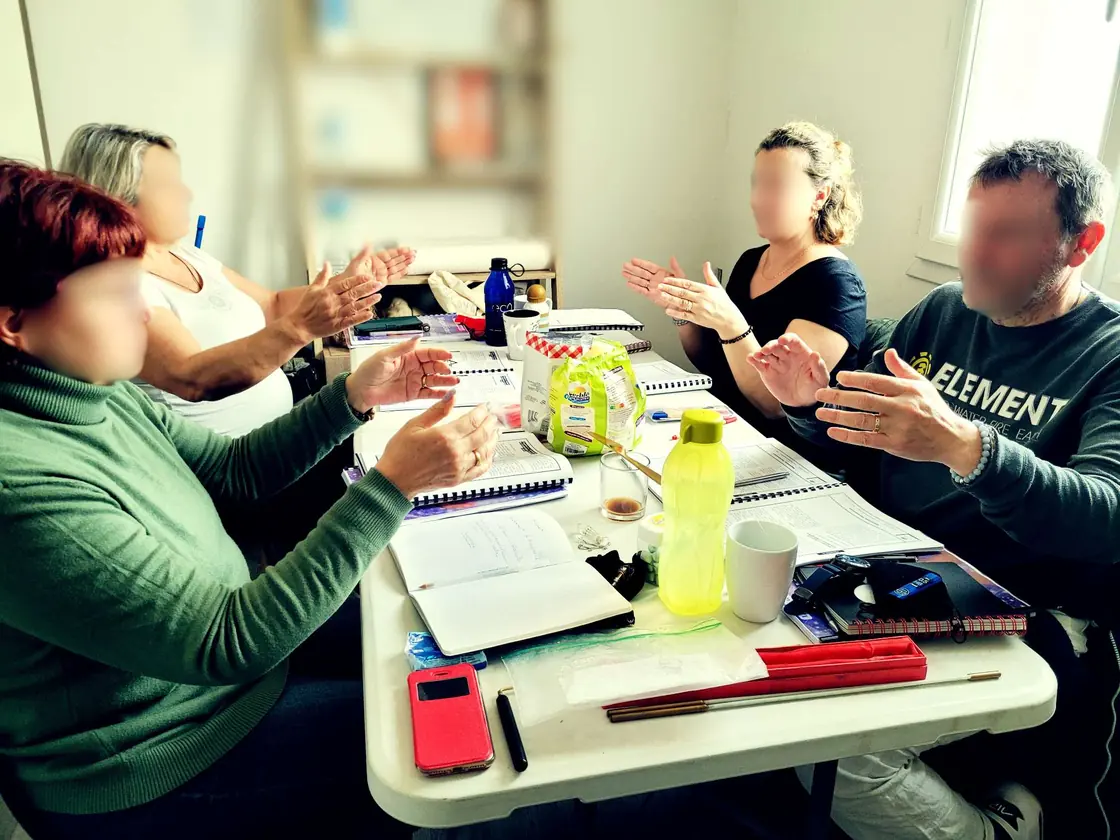 Participants à une formation en magnétisme pendant un exercice de ressenti avec les mains